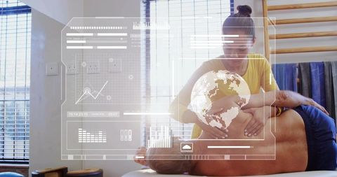 Physiotherapist applying manual therapy on rehab table with futuristic data and globe overlay