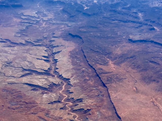 Aerial View of Tectonic Landscape with Cracked Terrain and Winding River - Download Free Stock Photos Pikwizard.com