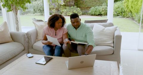 Mature Couple Reviewing Financial Documents in Modern Home