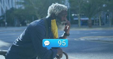 Urban cyclist reflecting with chat notification in city environment