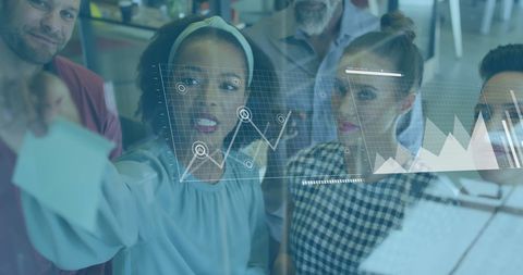 Diverse team analyzing data on digital interface with virtual graphs