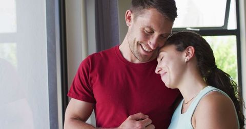 Happy Couple Sharing a Serene Moment by Window