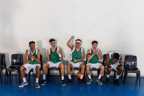 Young basketball team celebrating victory with enthusiasm