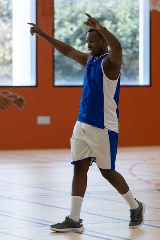 Triumphant Basketball Player Celebrating Victory Indoors