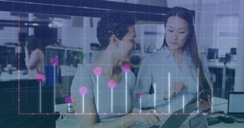 Diverse Female Colleagues Collaborating with Digital Data Overlay