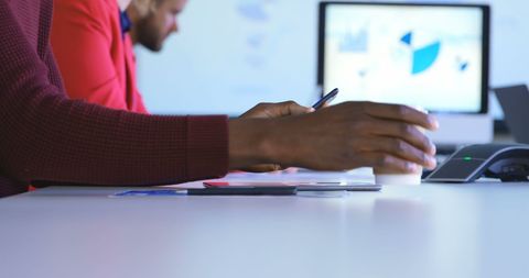 Male Executive Using Smartphone with Coffee in Modern Office Setting
