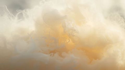 Swirling Golden Cloudscape Glowing with Ethereal Mist and Painterly Amber Haze Background