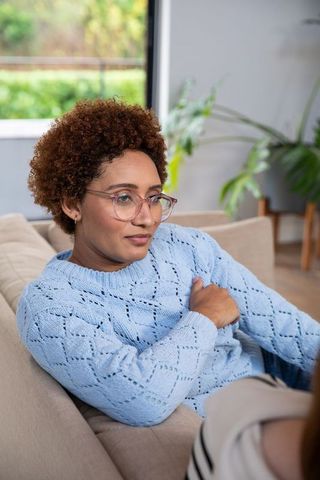 Relaxed African American Woman with Eyewear on Couch