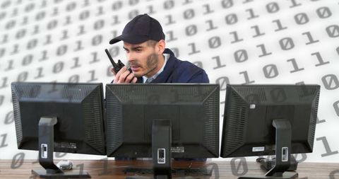 Security officer monitoring multiple screens for threat analysis