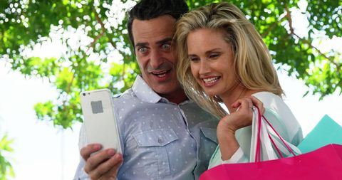 Cheerful Couple Taking Selfie Outdoors on Sunny Day