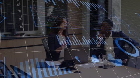 Diverse Business Team Discussing Data with Digital Charts in Modern Office