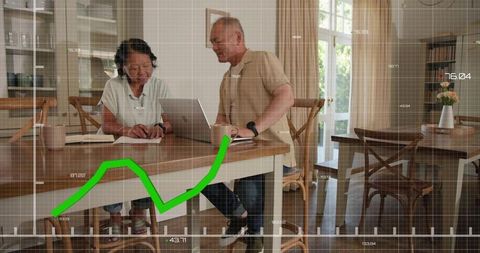 Senior chinese couple planning finances at home with laptop and green growth chart overlay