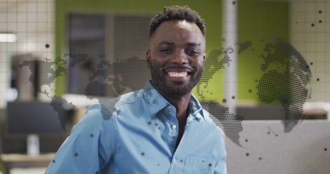 Confident Businessman with Digital World Map Overlay in Office Environment