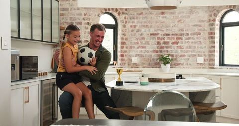 Playful Father-Daughter Bonding in Modern Kitchen