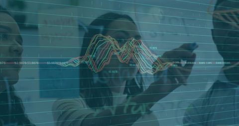 Team analyzing waveform data on glass board, woman pointing to waveform peak with stylus