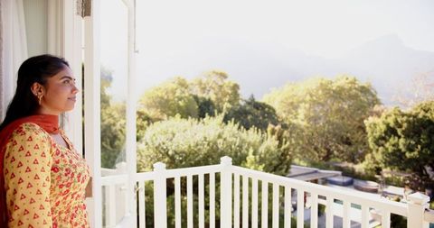 Woman Enjoying Scenic Natural View from Balcony