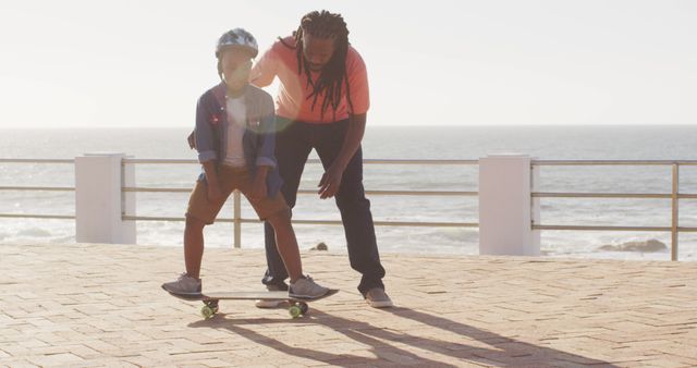 Father Teaching Son to Skateboard at Seaside Promenade - Download Free Stock Images Pikwizard.com