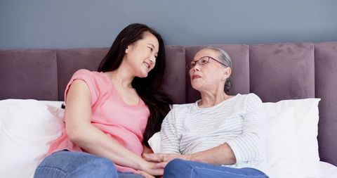 Mother and Daughter Sharing a Tender Moment on Bed