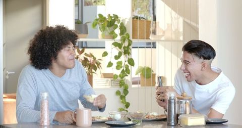 Cheerful Friends Enjoying Breakfast Together in Cozy Kitchen