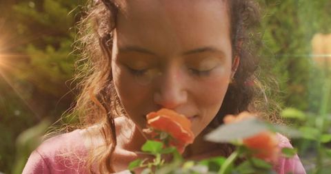 Close-up of Woman Enjoying Fragrant Flowers in Garden on Sunny Day - Download Free Stock Images Pikwizard.com