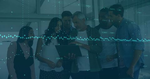 Diverse Business Team Analyzing Financial Data and Trends in Office Setting