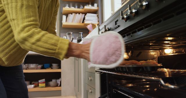 Person Baking Cupcakes in Oven Using Mitt in Cozy Kitchen - Download Free Stock Images Pikwizard.com