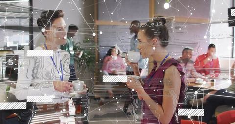 Women networking over coffee with digital connections in office