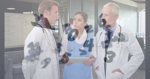 Medical Team Consulting with Technology in Modern Hospital