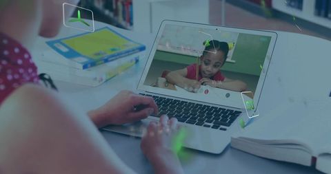 Teen typing on laptop triggering augmented learning icons during online tutoring session