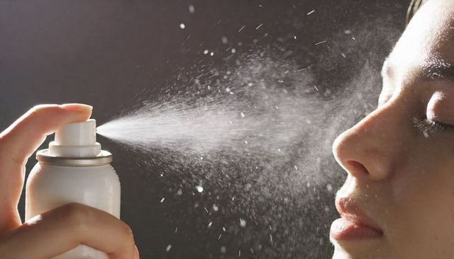Backlit facial misting spray delivering fine droplets for skin hydration and beauty refresh, rimlit