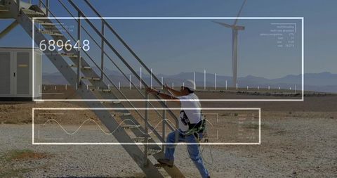 Wind farm technician climbing staircase with augmented reality overlay