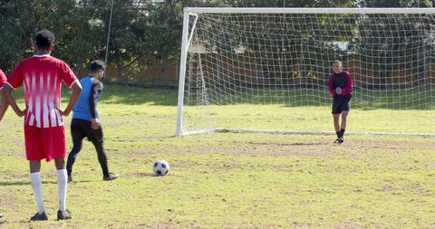 Soccer penalty kick exciting moment on sunny field