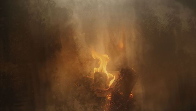 Burning Scroll in Fire Pit: Ember Glow with Rising Smoke