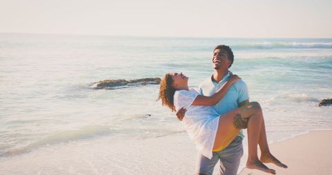 Romantic Couple Playing on Sunlit Beach - Download Free Stock Images Pikwizard.com