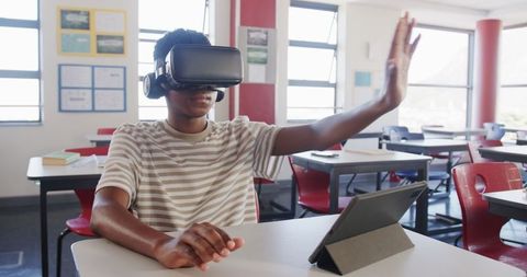 Boy Using VR Headset in Classroom for Interactive Learning