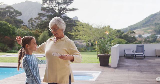 Grandmother and Granddaughter Enjoying Time Together Near Pool - Download Free Stock Images Pikwizard.com