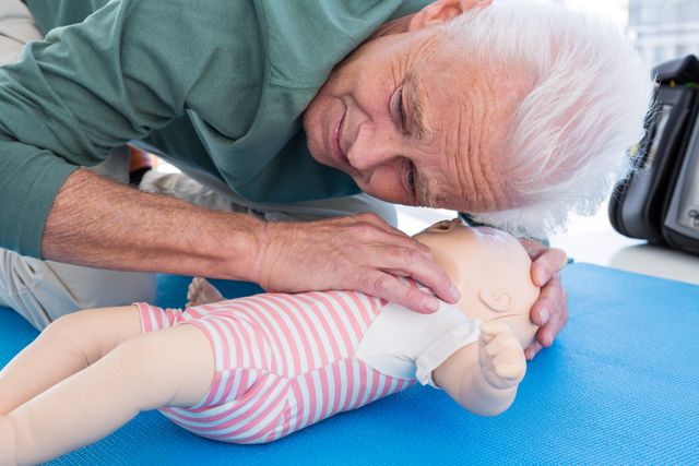 Senior Paramedic Practicing Infant CPR on Dummy - Download Free Stock Photos Pikwizard.com