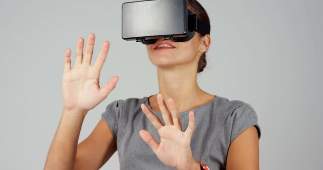 Woman Exploring Virtual Reality Using VR Headset in Gray Dress - Download Free Stock Images Pikwizard.com