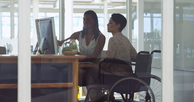 Disabled Woman in Wheelchair Collaborating with Colleague in Modern Office - Download Free Stock Images Pikwizard.com