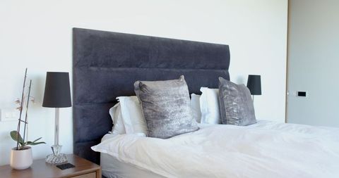 Modern Bedroom with Grey Headboard and Minimalist Design - Download Free Stock Images Pikwizard.com