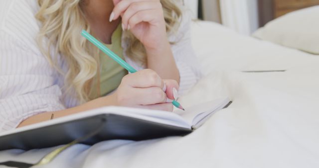Woman Journaling on Bed with a Pencil - Download Free Stock Images Pikwizard.com
