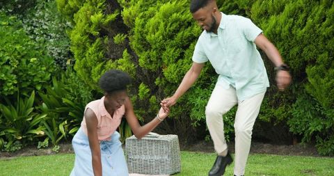 Young Couple Enjoying Sunny Picnic with Laughter and Joy