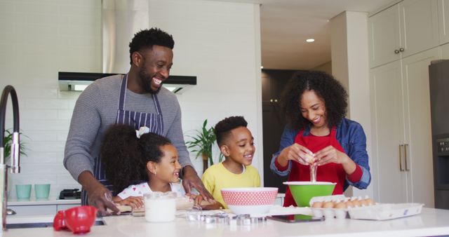 Family happily cooking and baking together in a modern kitchen, creating joyful memories. This image can be used in marketing campaigns for kitchen appliances, family-oriented products, or food recipes. It promotes themes of family bonding, joy, and home life.