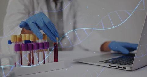 Scientist handling blood samples in laboratory with dna strand overlay
