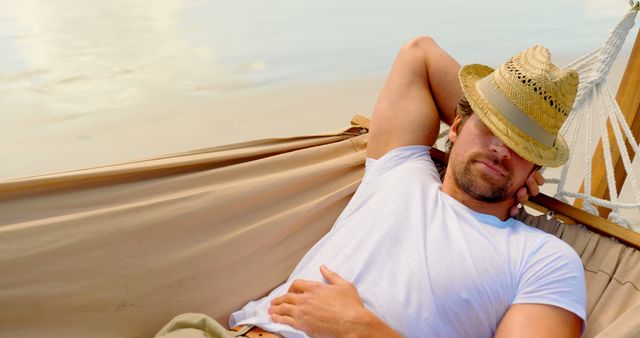 Man Sleeping in Hammock at Beach Wearing Straw Hat - Download Free Stock Images Pikwizard.com