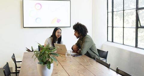 Creative Colleagues Collaborate in Modern Office Meeting Space