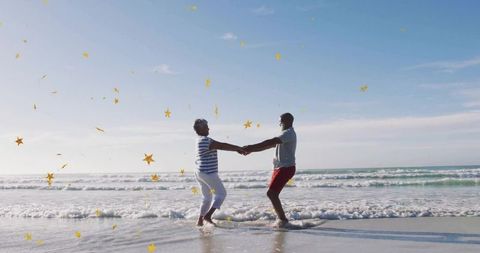 Joyful Mature Couple Dancing by Ocean with Star Confetti Outdoors
