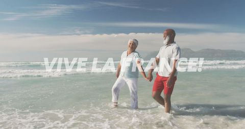 Elderly couple walking along seaside at sunset with 'vive la france' text
