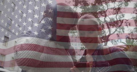Teen Girls with USA Flag Overlay Checking Smartphone on City Street