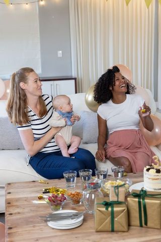 Diverse Friends with Baby Celebrating Birthday with Cake at Home